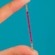 Sleek Art Deco 9ct Gold Ruby Diamond Knife Edge Pendant, Ruby line and Diamond ends on blue background