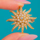 15ct Gold Pearl & Diamond Flower Brooch Pendant, front of the Pearl and Diamond flower on blue